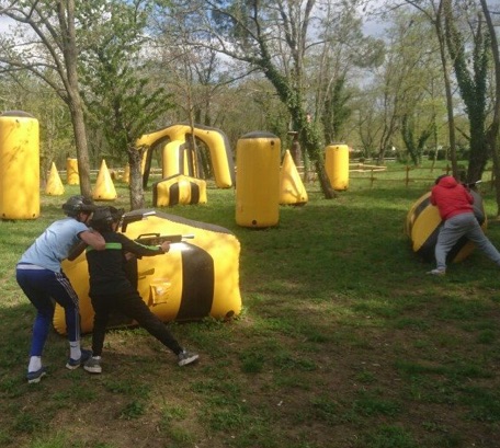 Photo du terrain de laser game en plein nature : de nombreux obstacles  et modules gonflables jaunes sont disposés.